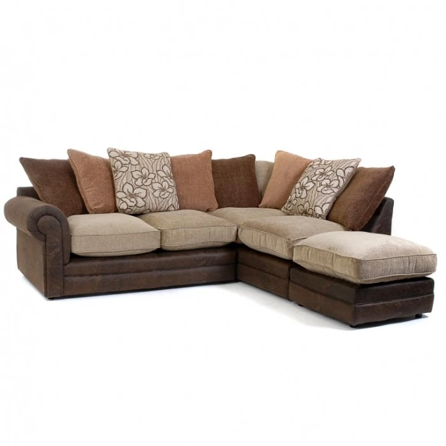 the large sectional couch is facing an ottoman