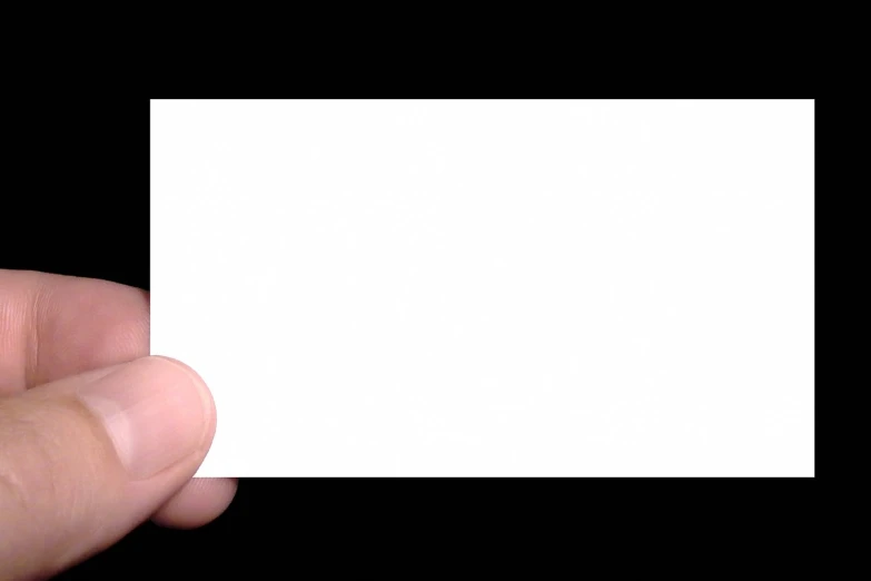 a hand holding a small blank card