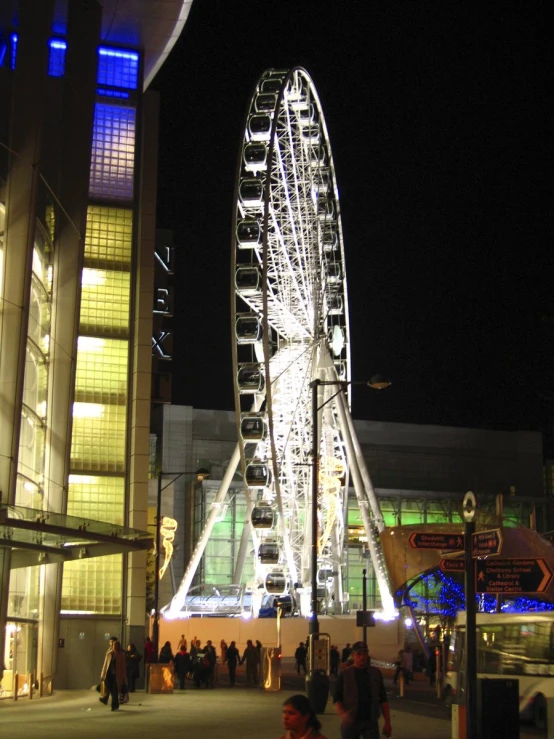 an amut park at night with the ferris wheel lit up