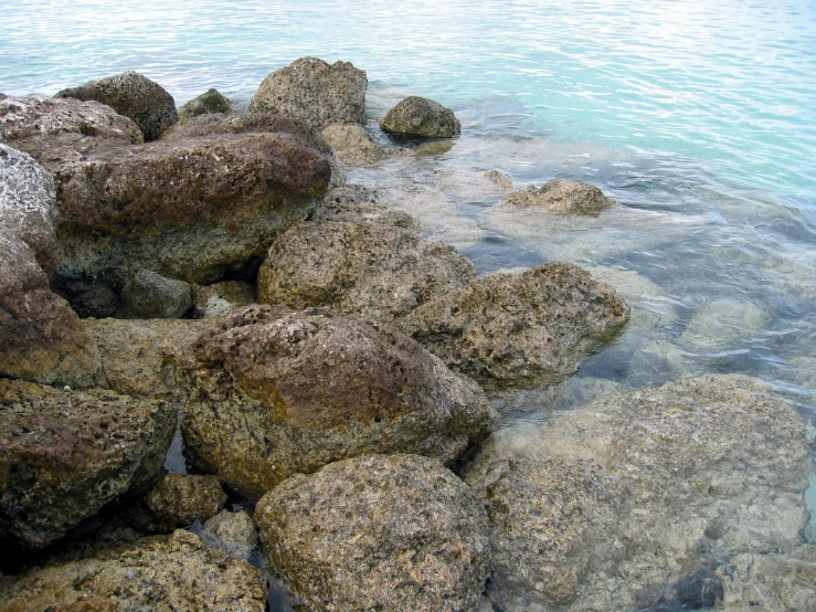 there are some rocks in the water at this beach