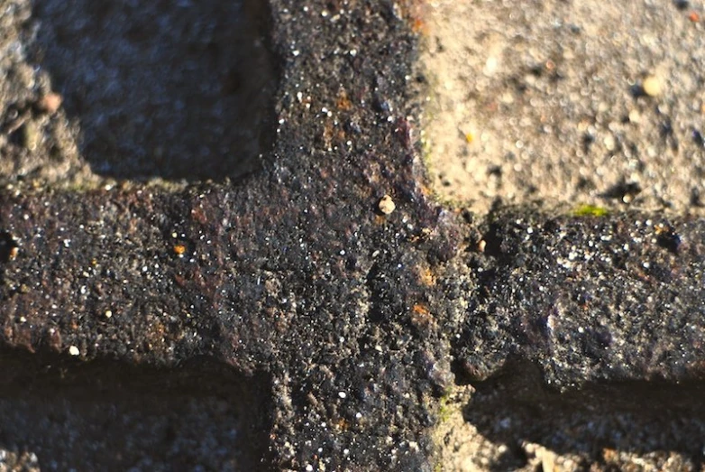 the surface of an old stone wall is covered in dirt
