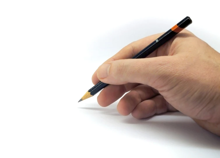 a person writing on a paper with a pencil in their hand
