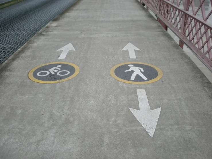 a pedestrian walkway with two signs that say one way