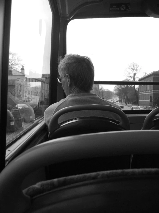 a man sitting in a truck looking out the window