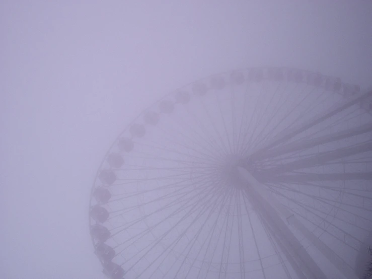 a circular metal object covered in snow and fog