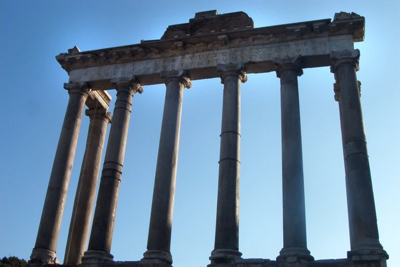 a building with many large columns against a blue sky