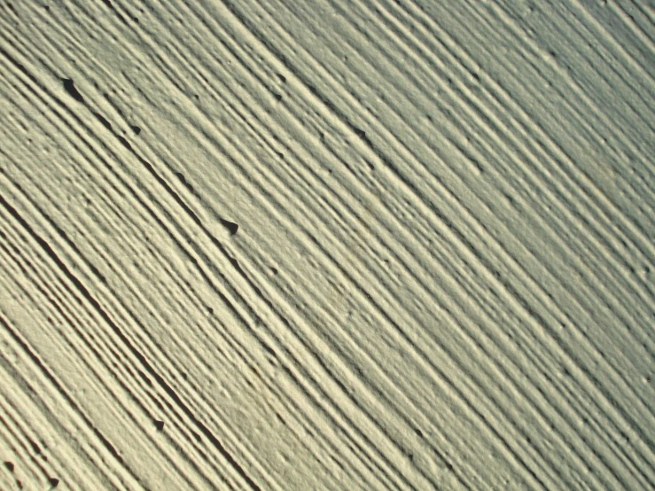 the sand is smooth and has little ridges in it