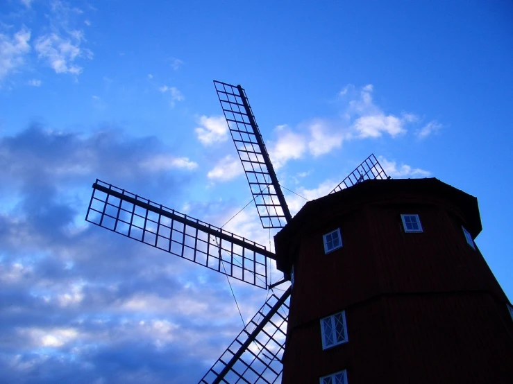a small windmill is standing against the blue sky