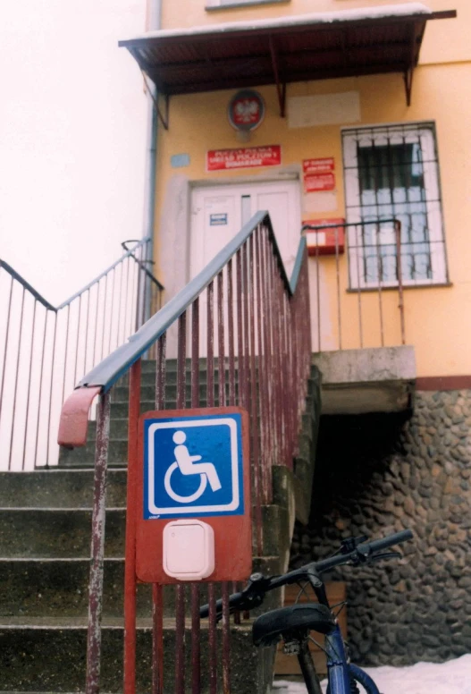 a stair area with a handicap sign and a bike