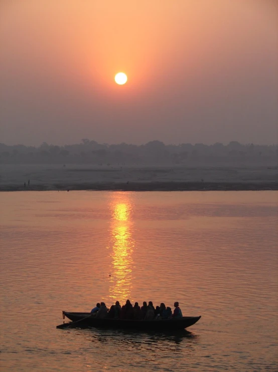 a small boat filled with people on a body of water