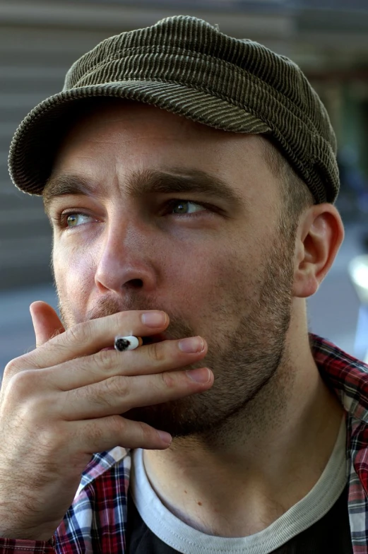 a man with a hat and a pipe in his hand