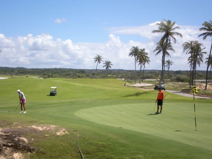 two men on a golf course practicing their golf ss