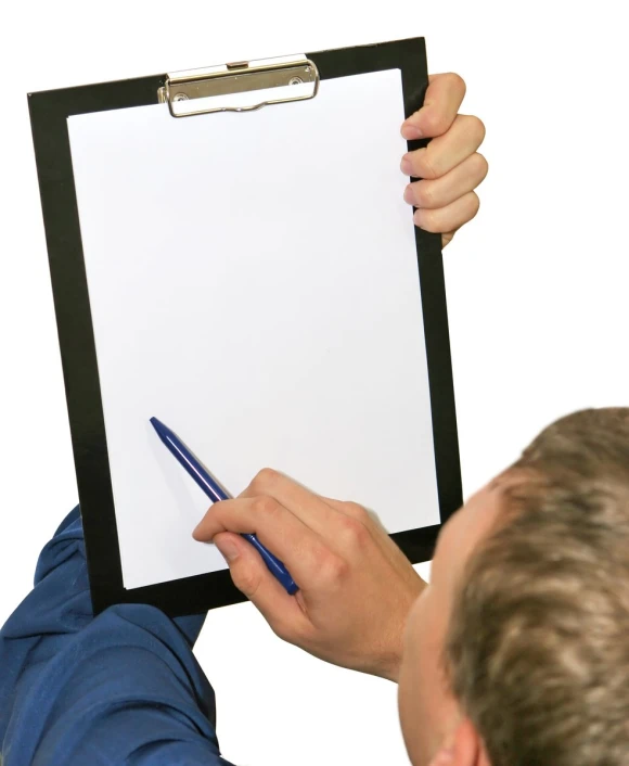 a man holding up a clipboard with a pen and paper on it