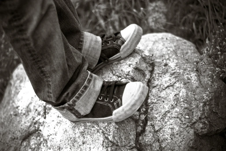 an old person stands on the edge of a rock