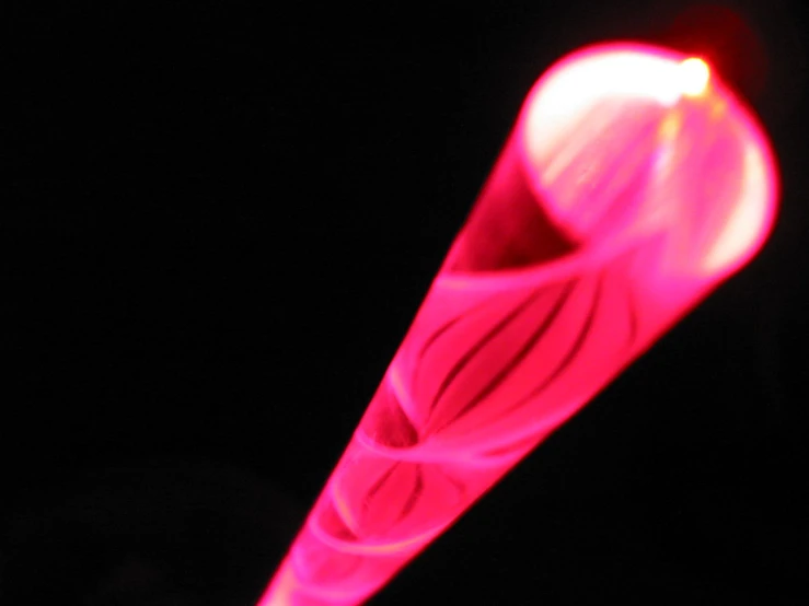 a red object is spinning against a black background