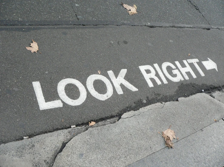 a painted arrow on the asphalt on the street