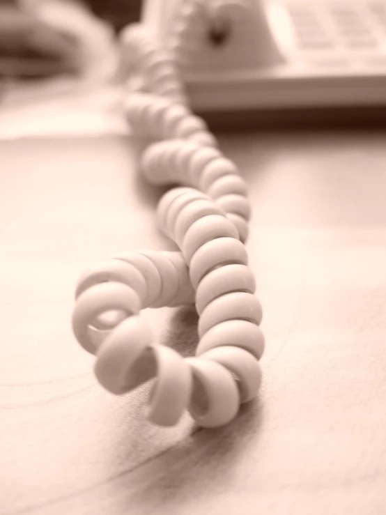 a phone and a cable sitting on a table