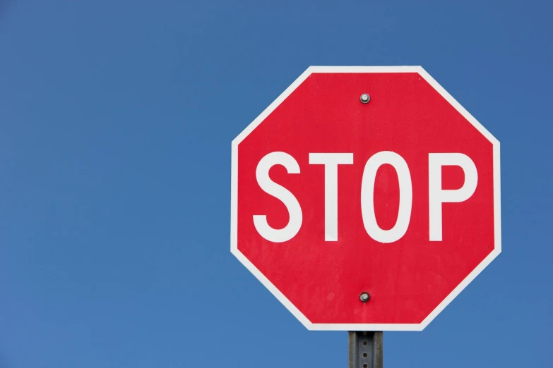 a red stop sign on top of a pole