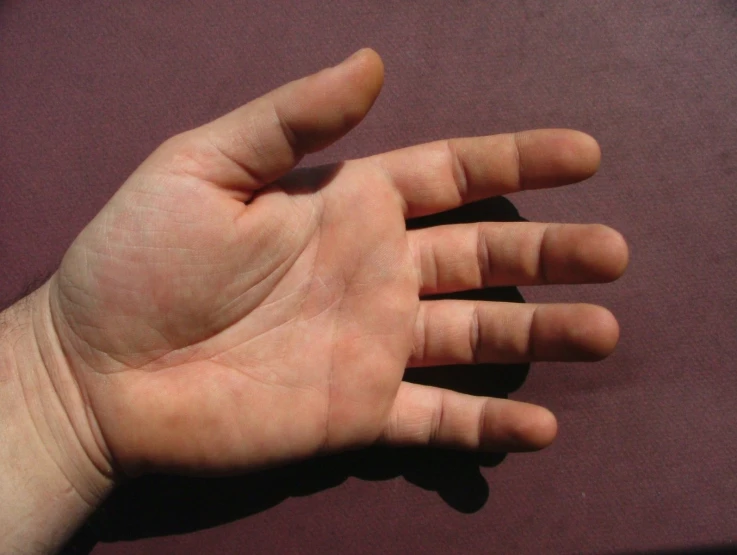 a man's hand with his left arm extended