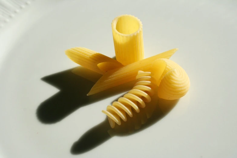 three pieces of pasta on a white plate