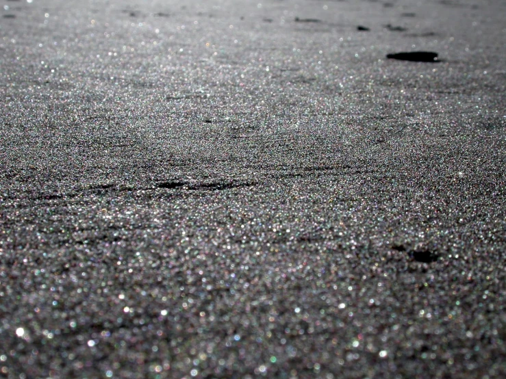 the sand is almost covered with tiny drops of water