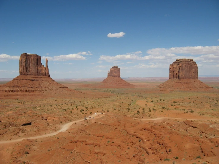 an aerial view of two big rocks in the middle of the desert