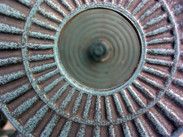 the top of a purple circular shaped object with small icey pieces of frost on it