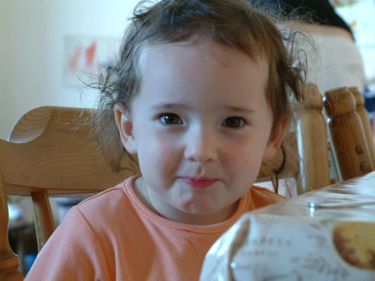 the  is eating her food at a table