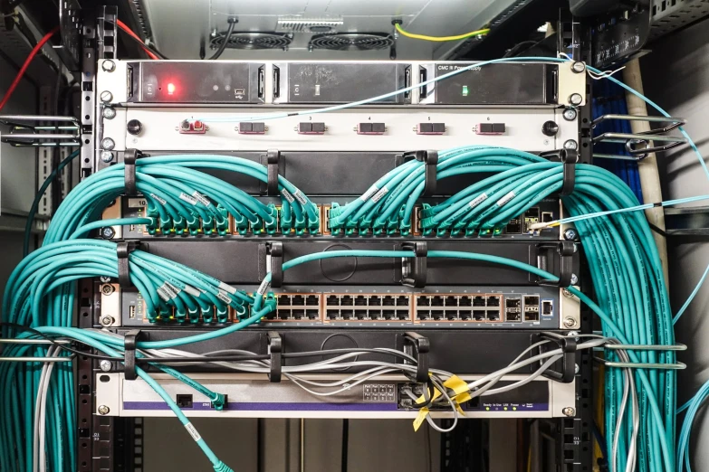 a computer rack with wires and sockets