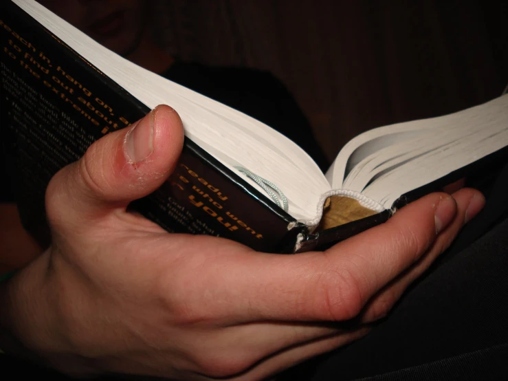 a man is opening a book with its front end showing