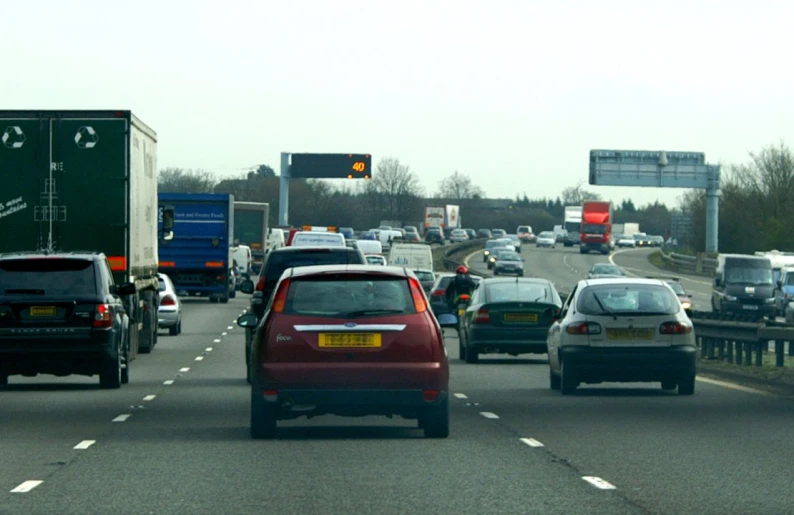 a bunch of cars are driving on a road