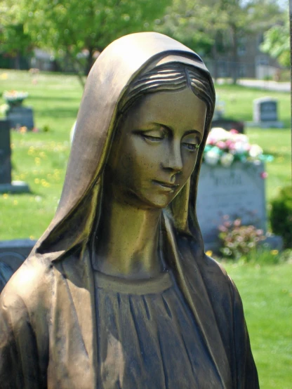 a statue of a woman with head bowed on the side