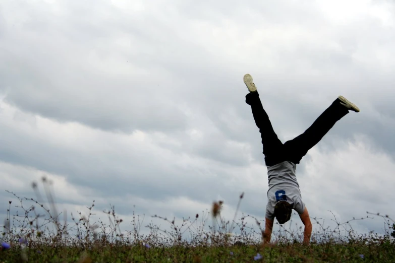 a person doing a handstand on a field