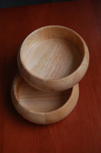 two wooden dishes on a wood table