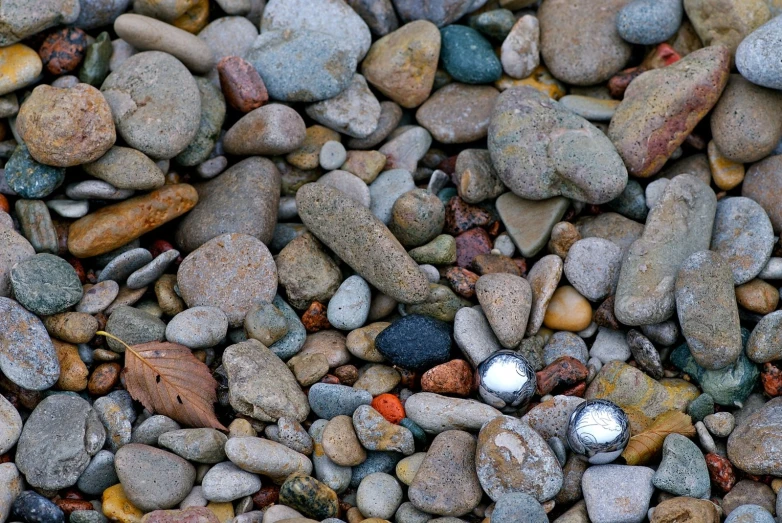 a rock beach with some white balls placed on top