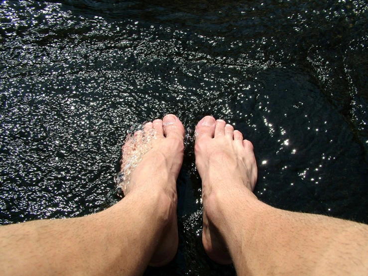 a couple of feet standing in the water