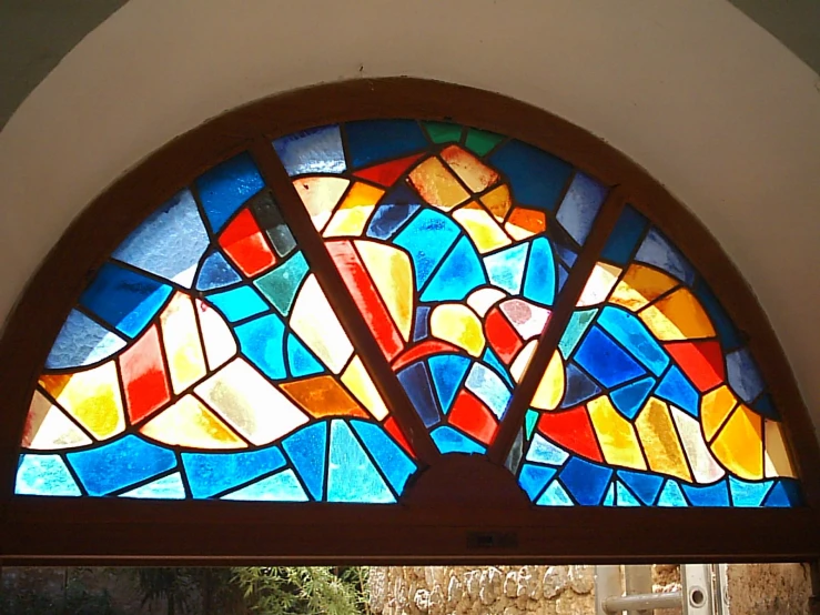 a stained glass window is shown in a wall