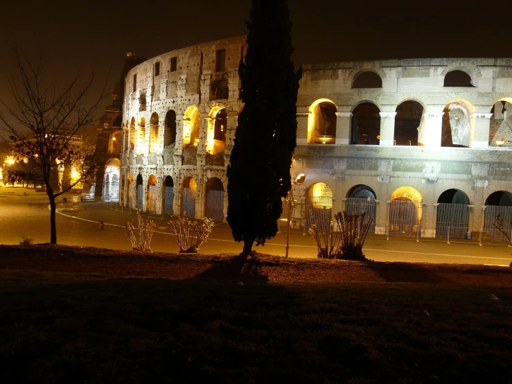 a large building with several windows lit up at night