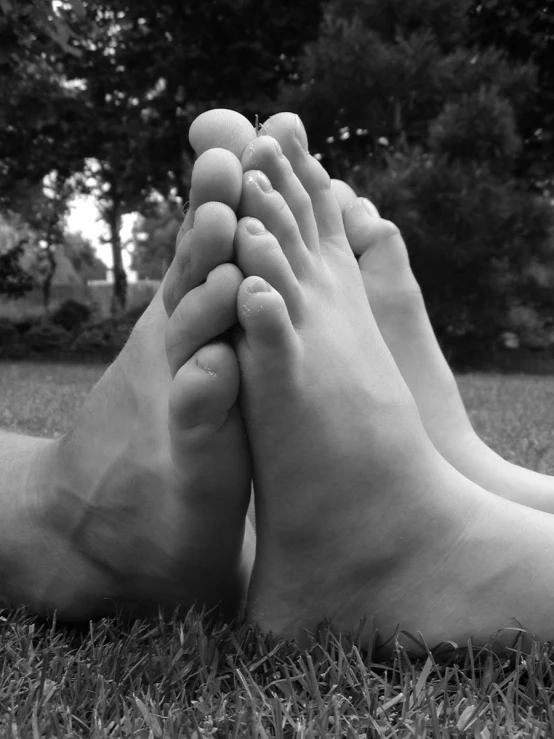 a person laying down with their feet crossed