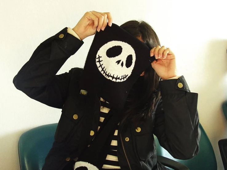 woman in black jacket with skull print on hood