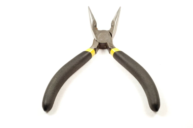two pairs of pliers on a white surface