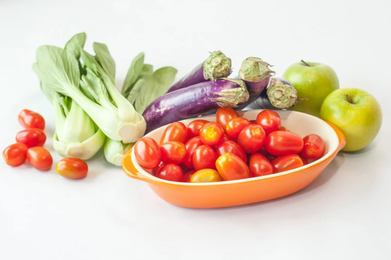 bowl full of tomatoes, peppers, and onions arranged on table