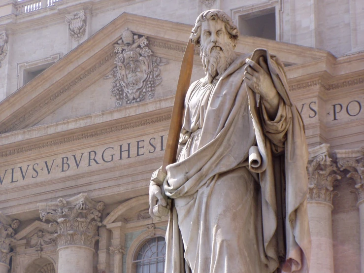 a large stone statue sitting on top of a building