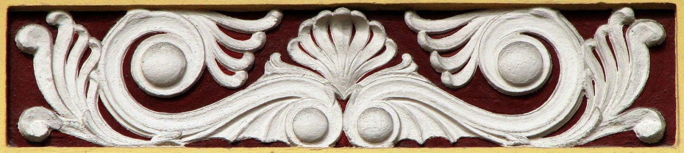 decorative white capital on red and yellow paper