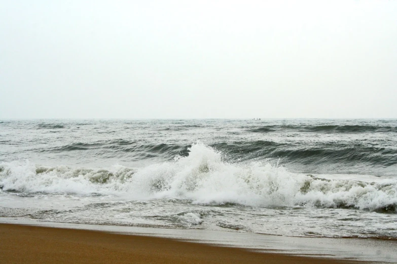 a big wave on the beach near the shore