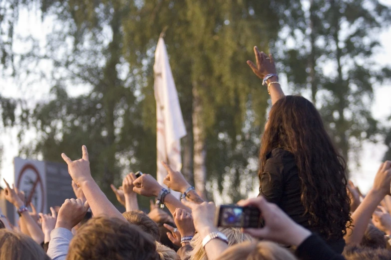 a woman standing in front of a crowd of people