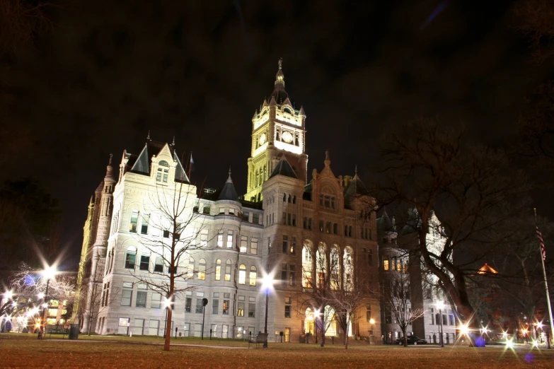 lights shine on the tall building in the evening