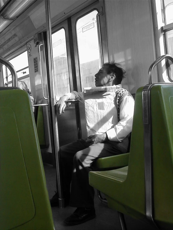 a man sits on the seat of an empty train