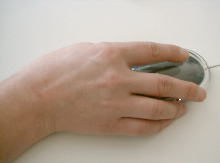 a person using a mouse on top of a white surface