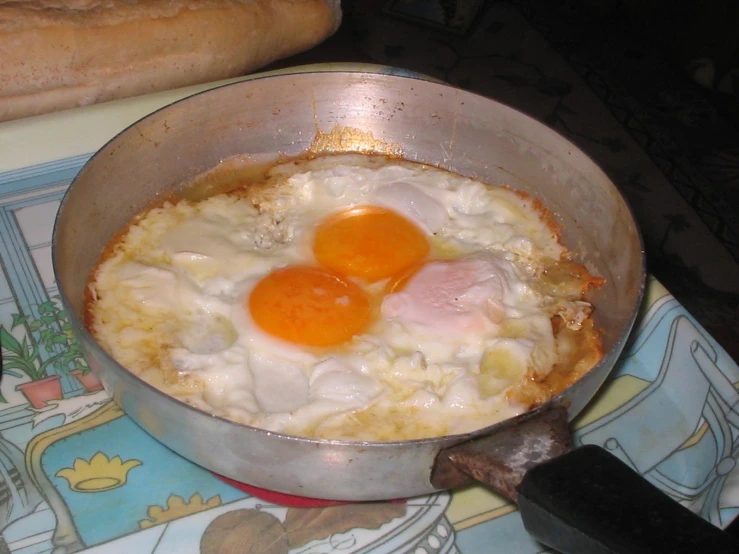 a pan of eggs and bread are cooking